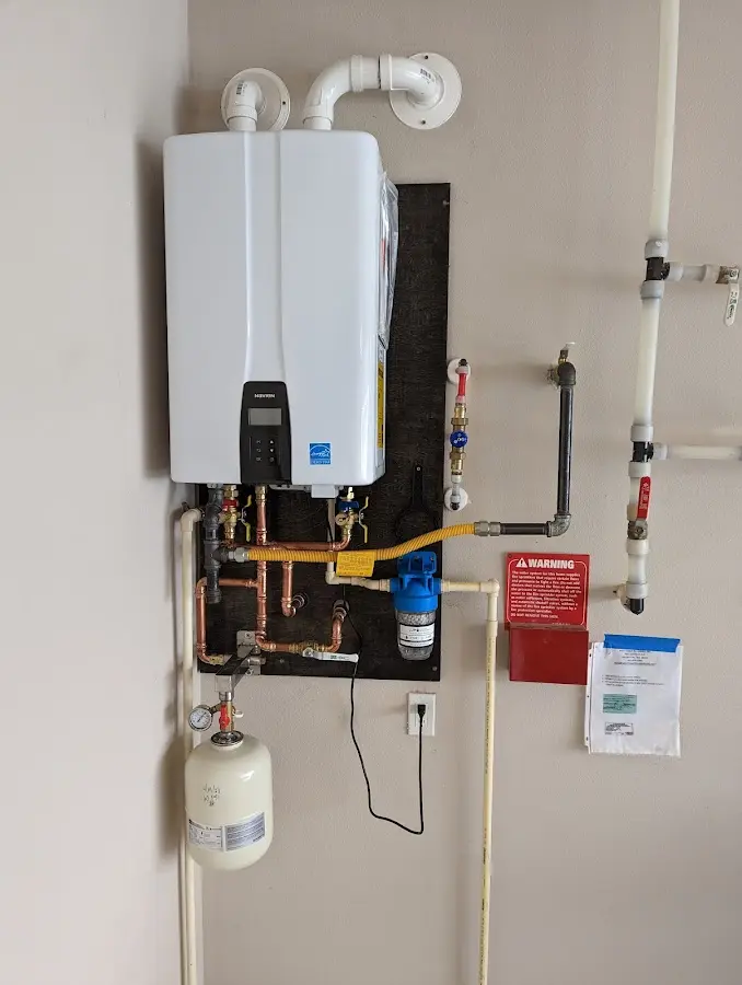 Professional plumber installing copper piping in a Ashville home